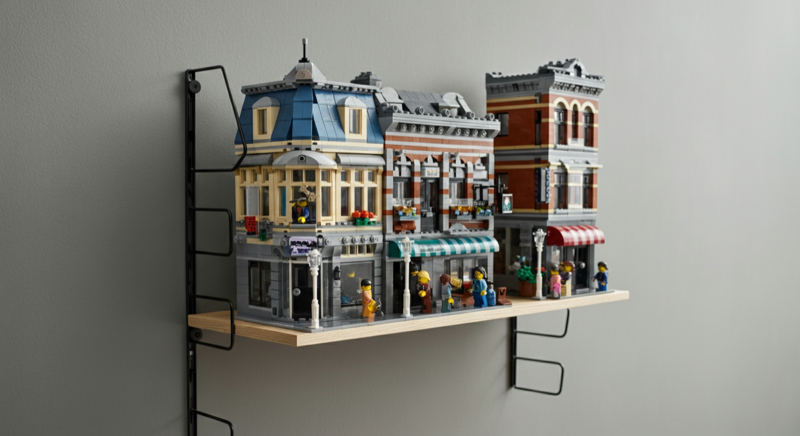 LEGO modular buildings lined up on a wall shelf